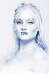 blonde in a white dress with blue makeup. The Snow Queen.