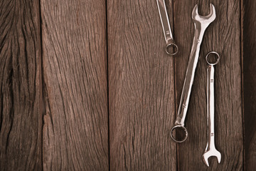 wrenches on wood background