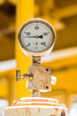 abstract soft focus pressure gauge with pipeline construction at