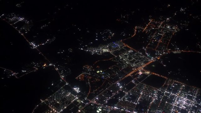 4K footage arial view of flying drone through the night light city scene