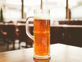 Glass of beer on a dark pub