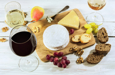 Photo of wine, cheese, grapes, nuts, bread at tasting
