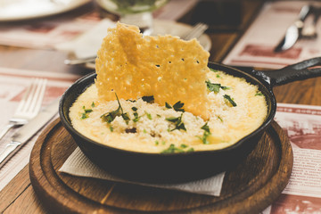 Cheese corn porridge. Banosh - Ukrainian Hutsul meal (maize porridge) with bacon, cracklings and...