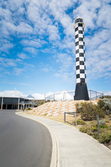 Asphalt road with Lighthouse .at the little coastal town of Myalup near Bunbury Western Australia .