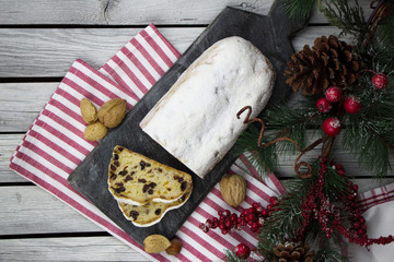 Christmas stollen. Traditional German dessert on the rustic wooden background. Homemade bakery. 