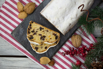 Christmas stollen. Homemade German dessert with nuts and berries. Rustic style.