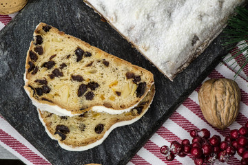 Christmas stollen. Traditional German dessert on the stone cutting board. Homemade bakery. 