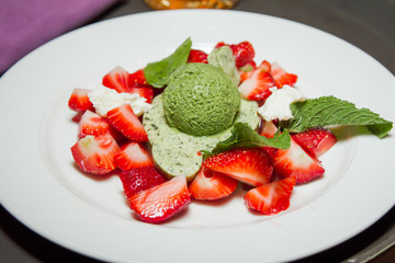 Ice-cream balls with fruit in cafe