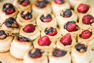 Assortment of Fresh Pastry on Table with Flowers