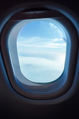 clouds in the aircraft's porthole , selected focus .