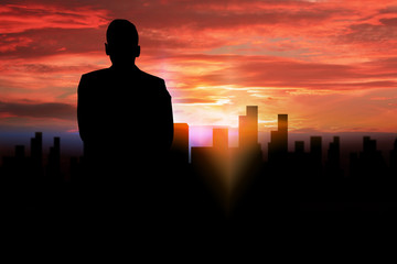 Fototapeta premium silhouette businessman standing looking to the city.
