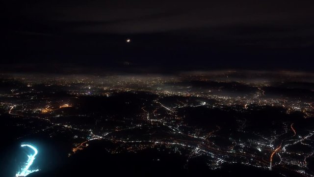 4K footage arial view of flying drone through the night light city scene