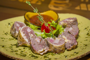Meat loaf served with lettuce and tomato.