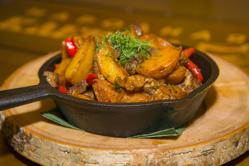 Fried potatoes with meat and mushrooms.