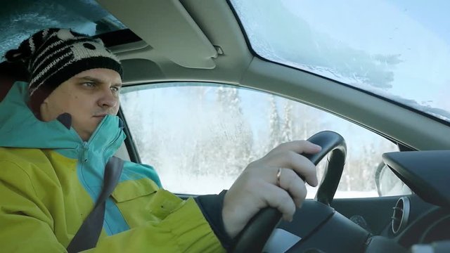 Man drivers the car in slow motion on winter landscape outdoors. 1920x1080