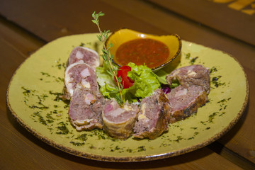 Meat loaf served with lettuce and tomato.