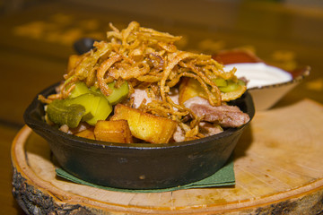 Potatoes fried with pork and onions.