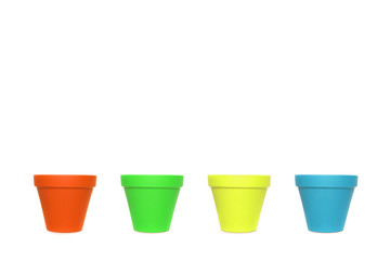 Four empty ceramics flowerpots in a row with different colours on a white background