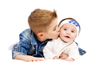 Portrait of brother kissing his little cute sister
