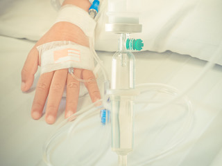 Saline intravenous (iv) drip on children hand in hospital. Health care and Medical equipment concept.