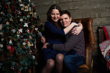 happy family posing under christmas tree 