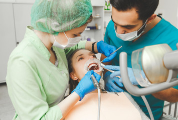 Girl on preventive teeth cleaning at the intern dentist.