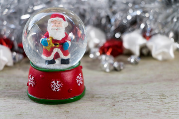 Santa claus with Christmas decoration on wood background.
