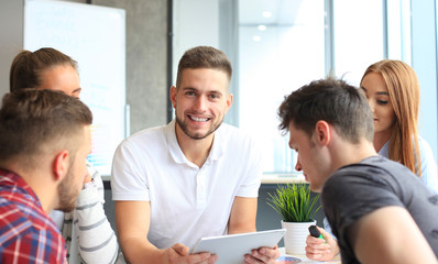 Group of young designers making sketches in office