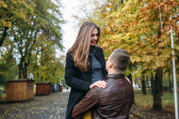 Fototapeta premium attractive happy couple walking in autumn park