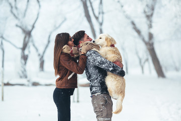 Young couple having fun in winter park