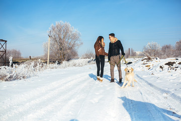 Young couple in love walking with dog