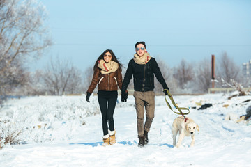 Fototapeta na wymiar Young couple in love walking with dog