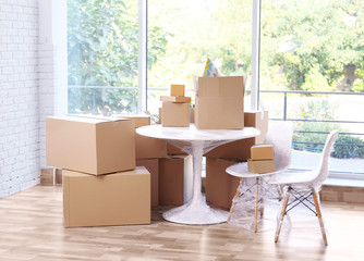House moving concept. Boxes and furniture in the room