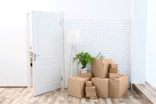 House moving concept. Boxes in empty room