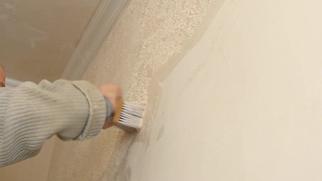Smoothing of impressive plaster on a wall. A finishing stage