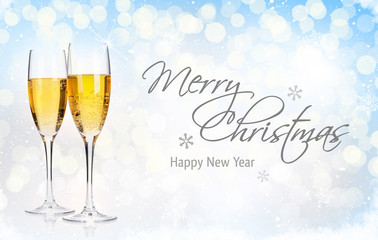 Two champagne glasses over christmas background