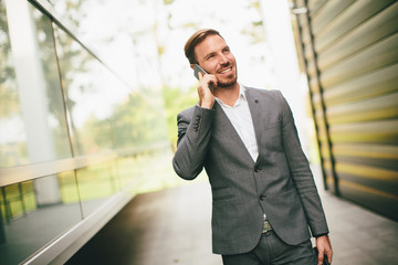 Fototapeta premium Stylish businessman walking outdoors