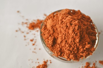 Red clay powder Montmorillonite in bowl isolated with copy space