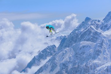 Naklejka na ściany i meble Flying snowboarder on mountains