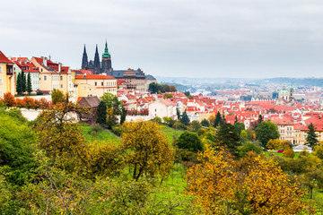 Fototapeta premium Autumn Prague panorama from Prague Hill with Prague Castle, Vltava river and historical architecture. Concept of Europe travel, sightseeing and tourism.