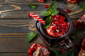 Glasses of pomegranate juice with fresh pomegranate fruits