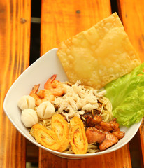 Crab noodles black pepper with prawn shrimp and vegetable in white bowl