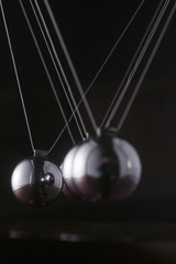 A chrome ball on a newtons cradle out of align