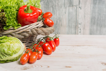 Variety of green and red fresh lettuce salad leaves, red paprika