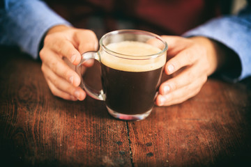 Barista in front of a cup of coffee