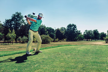 Male golfer. Teeing off with driver
