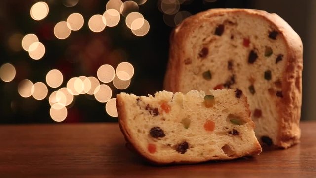 Male hand picking up a Brazilian panettone, a traditional pastry in Brazilian Christmas.