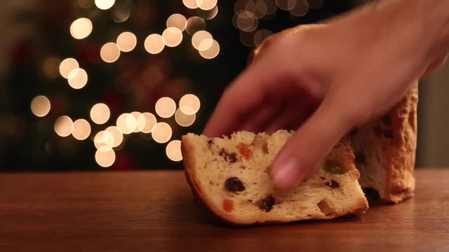 Male hand picking up a Brazilian panettone, a traditional pastry in Brazilian Christmas. Panning.