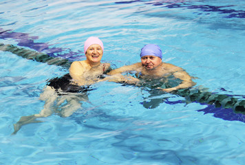 Middle Aged Couple In Swimming Pool