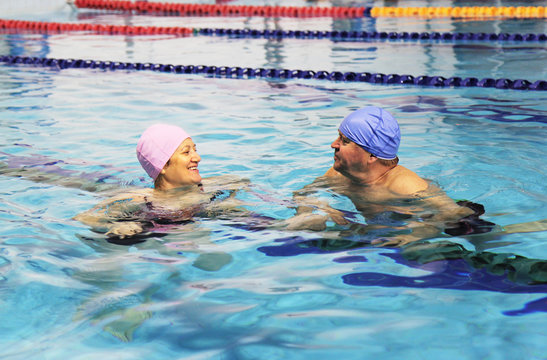 Middle Aged Couple In Swimming Pool